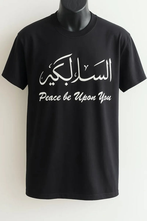 Black Assalamu Alaikum Arabic calligraphy T-shirt featuring السلام عليكم and Peace Be Upon You text in white print, modest Islamic streetwear tee for women, Muslim graphic shirt USA