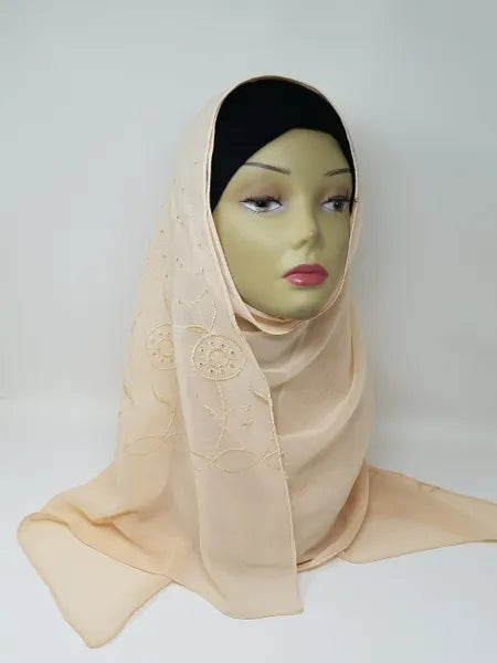 Light beige chiffon hijab draped on mannequin, soft breathable scarf for modest wear, lightweight fabric, smooth elegant texture, neutral tone hijab for everyday styling and formal outfits