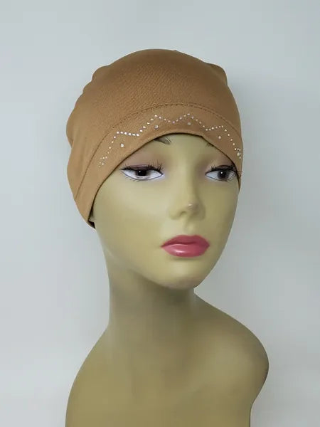 Beige stretch cap hijab on mannequin, soft fitted undercap for women, modest headwear, breathable fabric, everyday wear, smooth snug fit, neutral beige hijab cap for layering under scarves