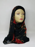 Black floral hijab draped on mannequin, soft breathable scarf with red flower pattern, smooth lightweight fabric, elegant modest head covering for women, flowy stylish hijab for everyday wear and special occasions