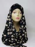 Black floral print hijab scarf for Muslim women displayed on mannequin, lightweight modest headscarf with floral pattern for everyday wear prayer and modest fashion styling