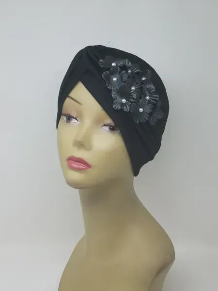 Black floral turban for women with flower detail, soft stretch fabric head covering, ready to wear turban headwear, full coverage modest headwear, lightweight breathable turban, slip on hijab alternative, comfortable daily wear turban, stylish black turban for women, easy wear head covering