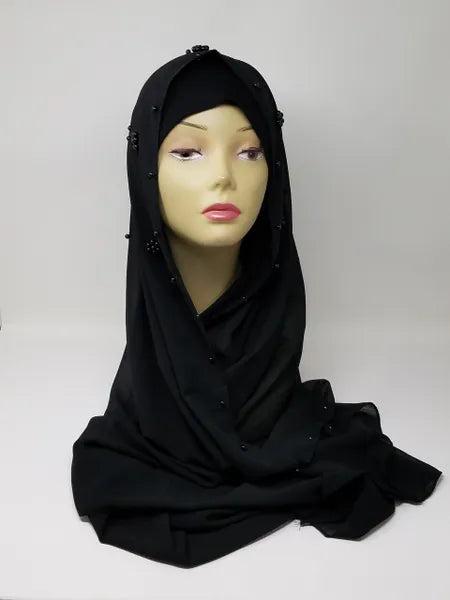 Black modest hijab scarf draped on mannequin, smooth soft fabric with full coverage, simple elegant wrap for everyday wear, classic black headscarf style