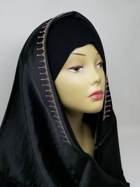 Black satin hijab scarf with delicate lace trim and rhinestone detailing along the edge, elegant modest fashion headscarf with smooth satin fabric drape designed for everyday wear, weddings, formal events, and stylish hijab outfits.