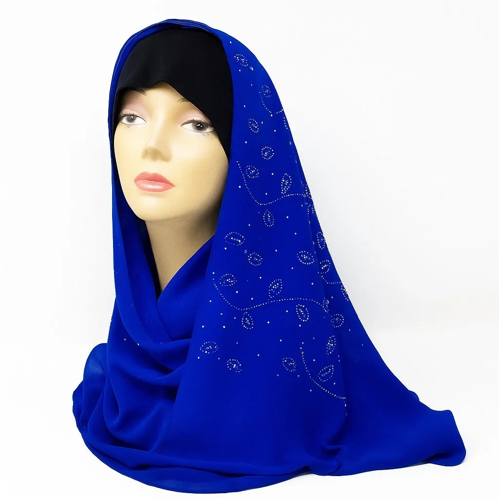 Royal blue chiffon hijab with rhinestone embellishments displayed on mannequin, elegant modest fashion scarf for Muslim women, lightweight breathable chiffon headscarf suitable for Eid, weddings, and everyday wear.