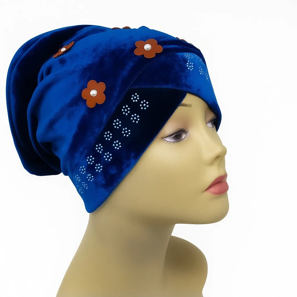 Blue velvet hijab bun cap with pearl and rhinestone flower decoration and attached bun piece worn on mannequin head, modest under hijab cap that creates bun shape for hijab styling from Affordable Hijab USA