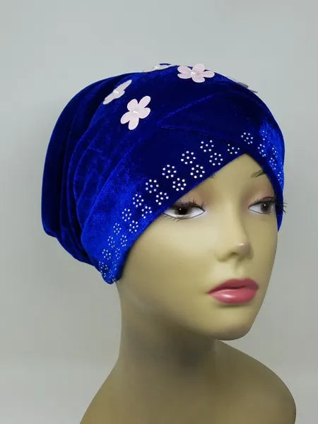Blue velvet hijab bun cap with pearl and rhinestone flower decoration and attached bun piece worn on mannequin head, modest under hijab cap designed to create bun shape for hijab styling from Affordable Hijab USA