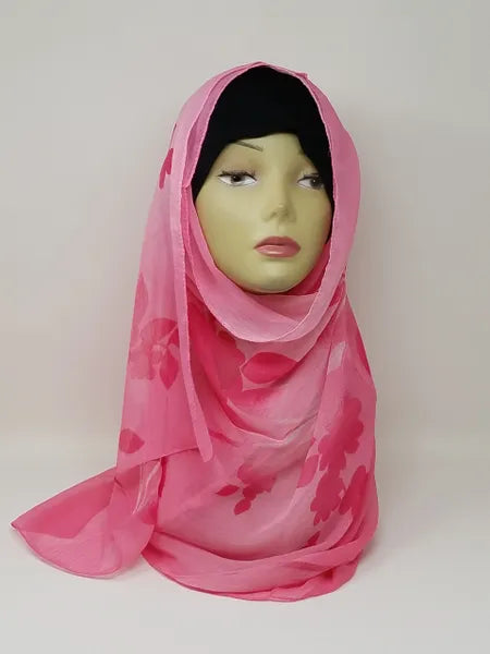 Bright pink floral georgette hijab draped on mannequin, lightweight breathable scarf with subtle floral pattern, soft textured matte fabric, flowy elegant modest head covering for women, stylish hijab for everyday wear and special occasions