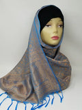 Brown and blue patterned hijab scarf with fringe edges draped on mannequin, lightweight modest wrap, soft textured fabric, full coverage stylish headscarf for everyday wear