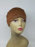Brown embellished cap hijab on mannequin, fitted undercap with decorative detail, modest headwear for women, soft stretch fabric, secure snug fit, stylish brown hijab cap for daily wear and layering