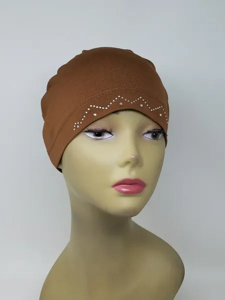 Brown embellished cap hijab on mannequin, fitted undercap with decorative detail, modest headwear for women, soft stretch fabric, secure snug fit, stylish brown hijab cap for daily wear and layering