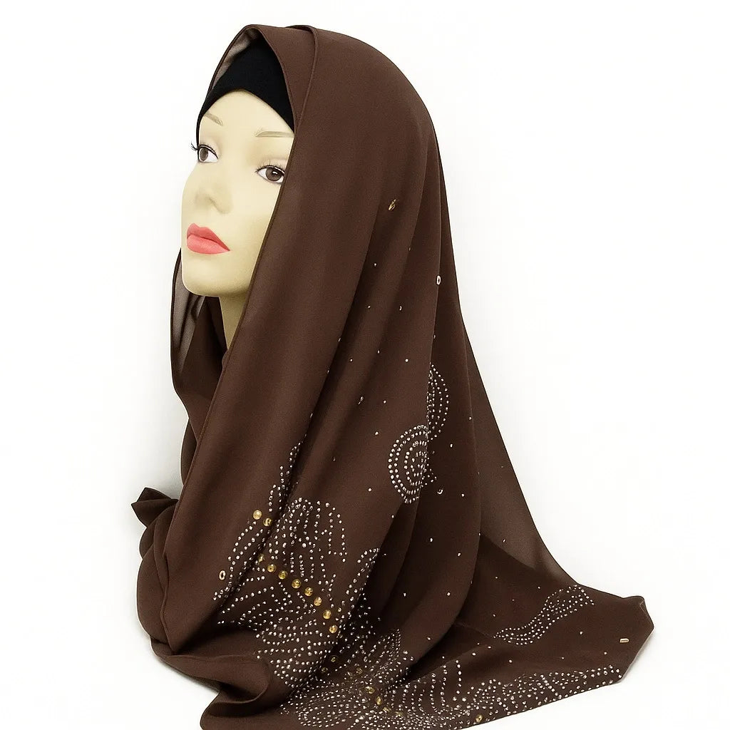 Brown chiffon hijab with rhinestone embellishments draped on mannequin head, elegant modest scarf for women from Affordable Hijab USA