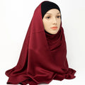 Deep burgundy silky finish hijab scarf draped on model, smooth satin look modest head scarf lightweight elegant wrap for daily wear and special occasions.