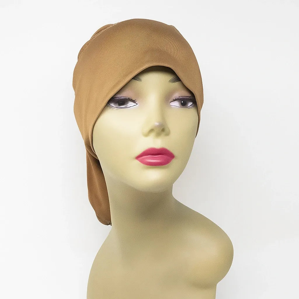 Camel instant hijab cap worn on mannequin, modest Muslim head covering for women, soft stretch hijab underscarf cap for secure everyday hijab styling and comfortable all day wear.