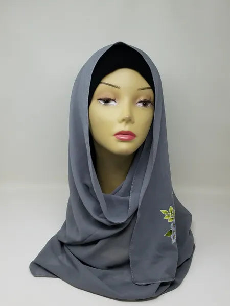 charcoal gray floral print hijab scarf for women, dark gray printed hijab with flower design, modest fashion scarf, soft breathable lightweight fabric hijab, stylish muslim headscarf for everyday wear and special occasions, comfortable wrap scarf for women, modern modest fashion accessory with floral pattern
