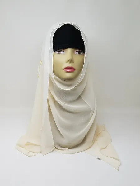 Cream chiffon hijab scarf displayed on mannequin, soft light neutral flowy fabric, lightweight breathable modest headscarf for women, elegant drape chiffon hijab for everyday wear and special occasions, Affordable Hijab USA