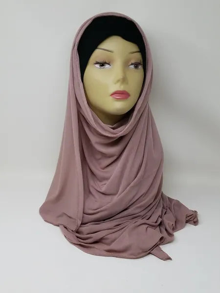 Dusty rose jersey hijab scarf on mannequin, soft stretch fabric, breathable modest headscarf for everyday wear, lightweight drape, comfortable jersey hijab for women, full coverage modest fashion scarf