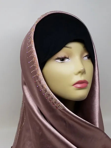 Dusty rose satin hijab scarf with lace trim and rhinestone detailing along the edge, elegant modest fashion headscarf with smooth satin fabric drape designed for everyday wear, weddings, formal events, and stylish hijab outfits.
