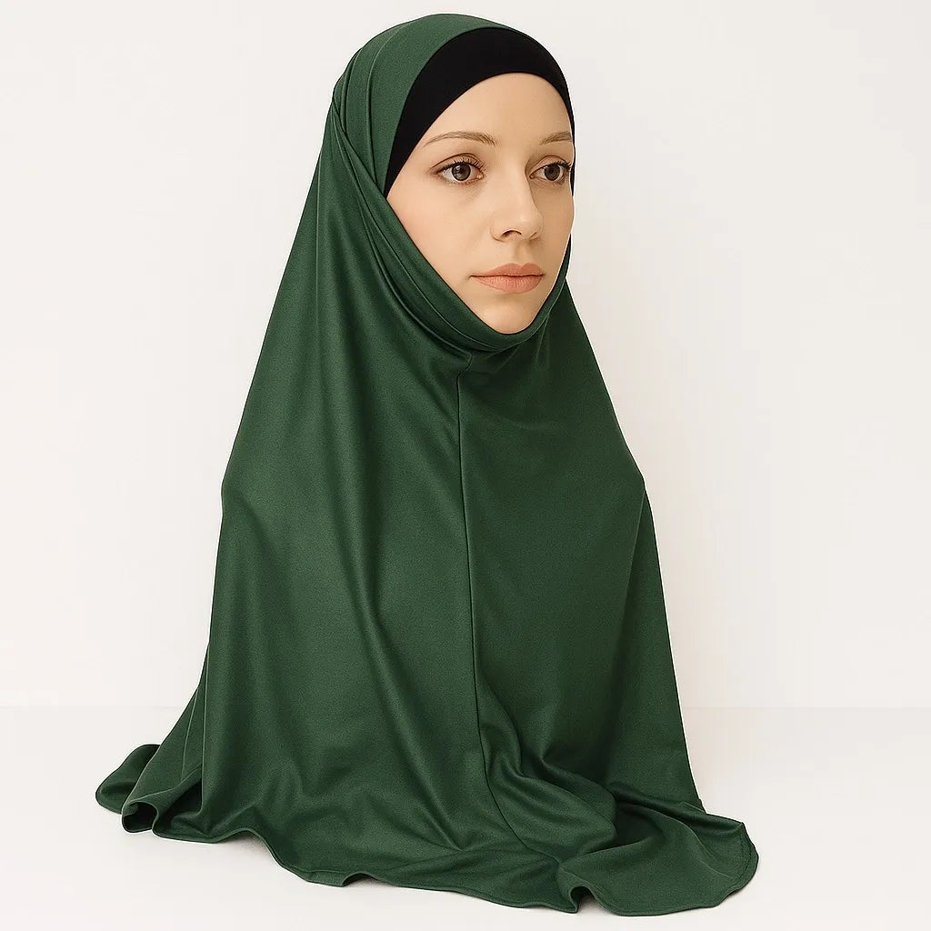 Model wearing emerald green full coverage khimar hijab with soft flowing drape and lightweight breathable fabric, modest Islamic head covering for women, front and side view on white background