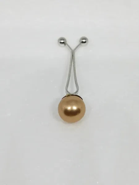 Gold pearl hijab pull pin used to secure scarves and hijabs, elegant modest fashion accessory with decorative pearl bead.