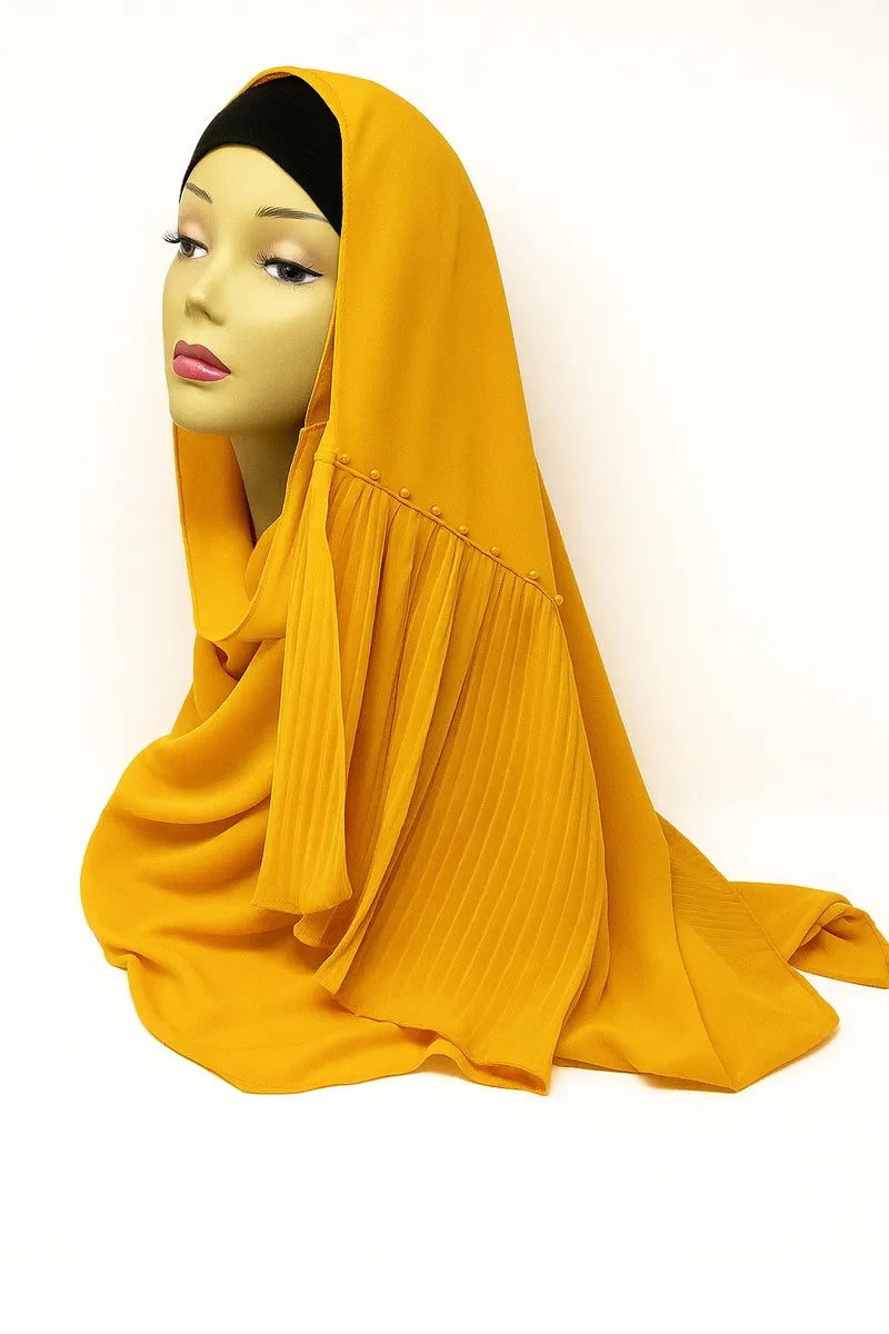 Golden yellow chiffon hijab scarf made from lightweight flowing fabric, elegant modest Muslim headscarf draped on mannequin for breathable everyday hijab styling.