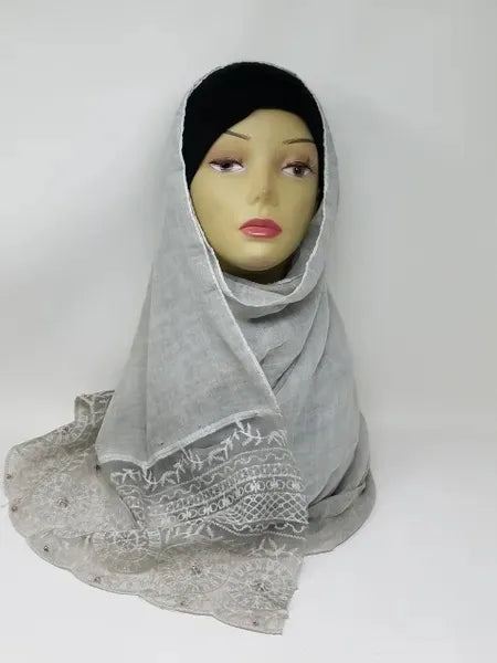 light gray hijab scarf draped on mannequin soft modest headscarf breathable everyday wrap neutral color muslim hijab for women simple elegant style