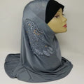 gray rhinestone one piece hijab on mannequin smooth fabric full coverage slip on modest Muslim headscarf elegant simple everyday wear soft drape side view clean white background