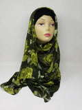 Green floral georgette hijab draped on mannequin, lightweight breathable scarf with leafy pattern, soft textured matte fabric, flowy elegant modest head covering for women, stylish hijab for everyday wear and special occasions