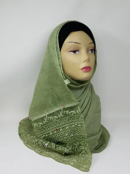 Green lace hijab scarf on mannequin, elegant floral lace modest scarf, soft draped hijab for women, dressy hijab style