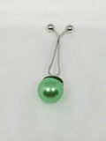 Green pearl hijab pull pin used to secure scarves and hijabs, elegant modest fashion accessory with decorative pearl bead.
