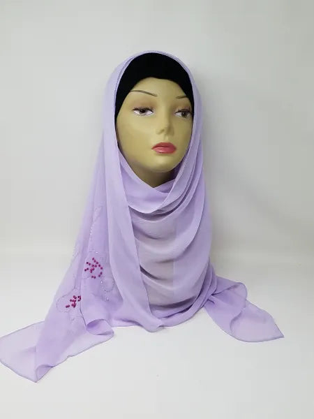 Light lavender chiffon hijab scarf displayed on mannequin, soft flowy fabric, breathable lightweight modest headscarf for everyday wear, elegant drape, smooth texture, perfect for casual, formal, and prayer wear, wrinkle resistant chiffon hijab for women, stylish modest fashion accessory