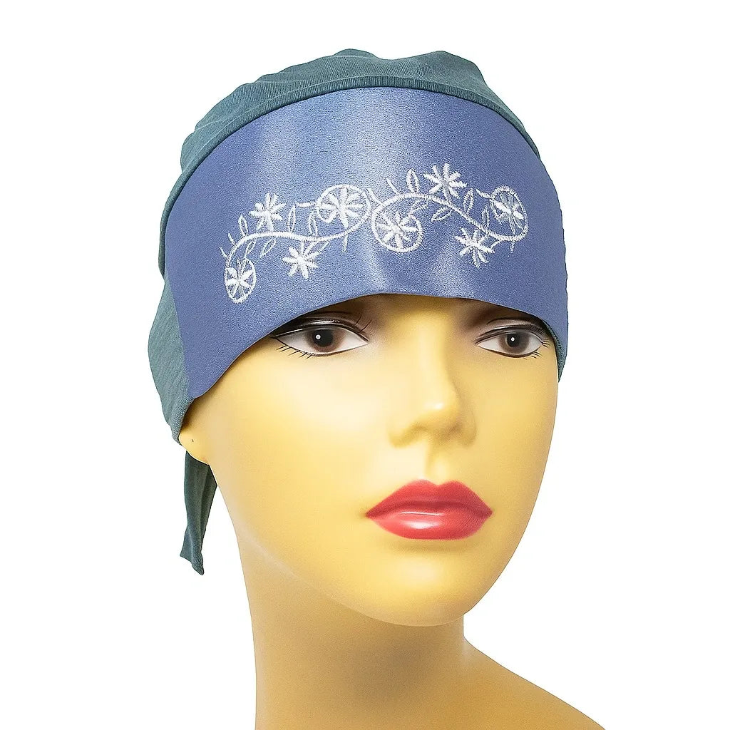 Light blue instant hijab cap with white embroidery worn on mannequin, modest Muslim underscarf headwrap for women, soft stretch hijab cap for secure and comfortable everyday wear.