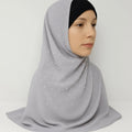 Light grey chiffon hijab with soft drape and full coverage styled on model with black undercap, modest fashion scarf for everyday wear in the USA