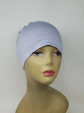 Light grey stretch cap hijab on mannequin, soft fitted undercap for women, breathable modest headwear, smooth snug fit, lightweight fabric, neutral grey hijab cap for layering or daily wear