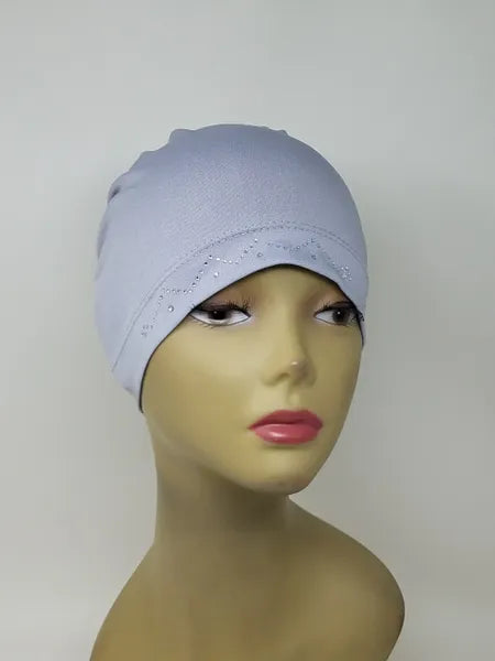 Light grey stretch cap hijab on mannequin, soft fitted undercap for women, breathable modest headwear, smooth snug fit, lightweight fabric, neutral grey hijab cap for layering or daily wear