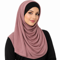 Mauve dusty rose jersey hijab scarf displayed on a mannequin with soft layered draping and full coverage on a white background.