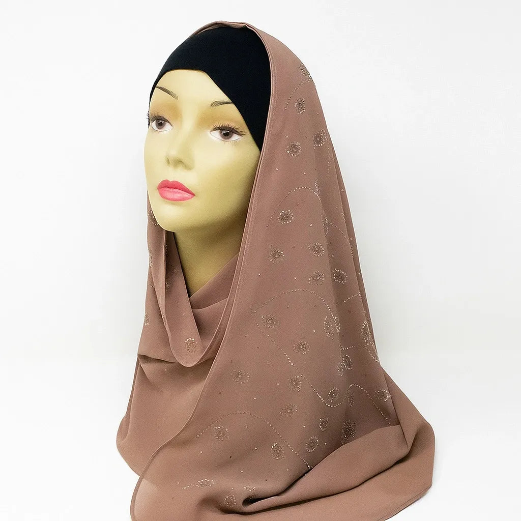 Mocha brown chiffon hijab with rhinestone embellishments draped on mannequin, elegant modest fashion scarf for Muslim women, lightweight breathable chiffon headscarf perfect for Eid, weddings, and everyday wear.