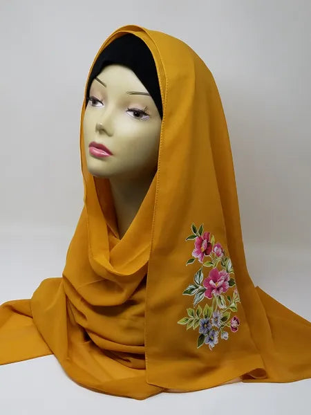 mustard floral print hijab scarf for women, yellow printed hijab with flower design, modest fashion scarf, soft breathable lightweight fabric hijab, stylish muslim headscarf for everyday wear and special occasions, comfortable wrap scarf for women, modern modest fashion accessory with floral pattern