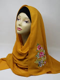 mustard floral print hijab scarf for women, yellow printed hijab with flower design, modest fashion scarf, soft breathable lightweight fabric hijab, stylish muslim headscarf for everyday wear and special occasions, comfortable wrap scarf for women, modern modest fashion accessory with floral pattern