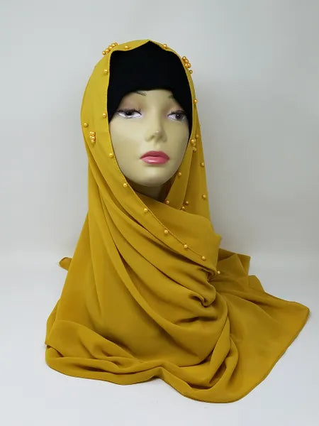 Mustard yellow hijab scarf draped on mannequin, smooth modest headscarf with full coverage, soft flowing fabric for everyday wear, elegant wrap style shown from front and back, simple clean design for casual and formal outfits