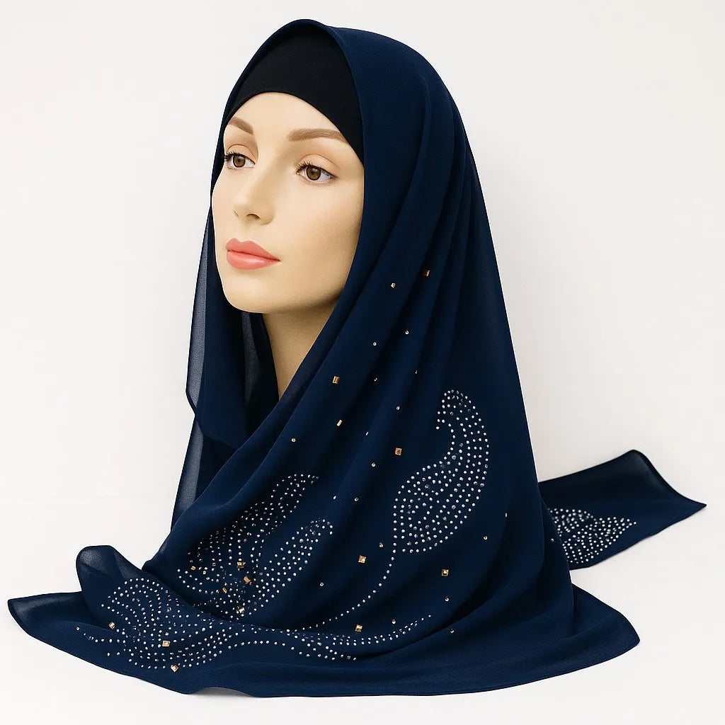 Navy blue embellished chiffon hijab with rhinestone details draped on mannequin head, elegant modest scarf for women from Affordable Hijab USA