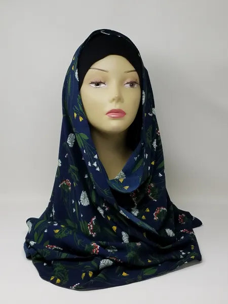 Navy blue floral print hijab scarf for Muslim women displayed on mannequin, lightweight modest headscarf with floral pattern for everyday wear prayer and modest fashion styling