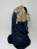 Elegant navy blue hijab with gold beaded embroidery and rhinestone embellishments draped on a mannequin head, luxury modest fashion scarf for special occasions, weddings, Eid, and formal Islamic wear.