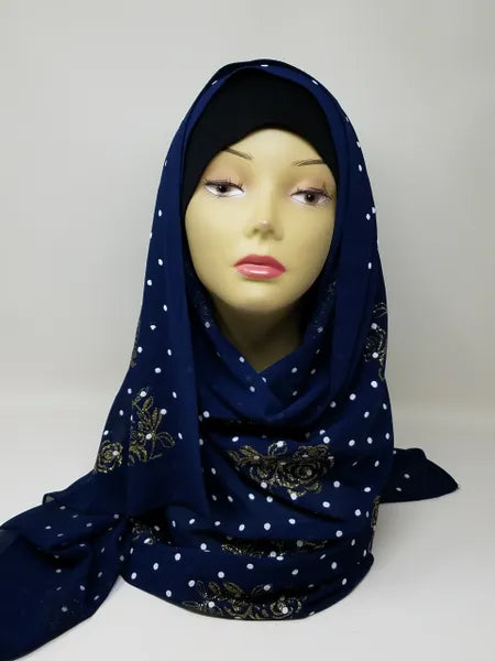 Navy blue chiffon hijab scarf with gold polka dot pattern displayed on mannequin head, lightweight modest fashion headscarf perfect for everyday wear and elegant hijab styling.