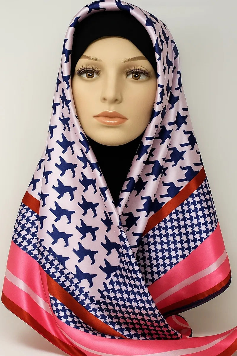 Navy and pink geometric satin square hijab with bold patterned print and soft lightweight fabric, modest fashion headscarf styled on mannequin for everyday wear, elegant Muslim hijab scarf for casual and formal outfits.