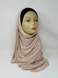 Nude jersey hijab scarf on mannequin soft stretch fabric lightweight modest headscarf smooth drape everyday wear breathable comfortable long scarf for women casual and formal styling neutral color hijab simple elegant wrap style for daily use
