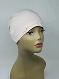 Off white stretch cap hijab on mannequin, soft fitted undercap for women, breathable modest headwear, smooth snug fit, lightweight fabric, cream hijab cap for layering or everyday wear