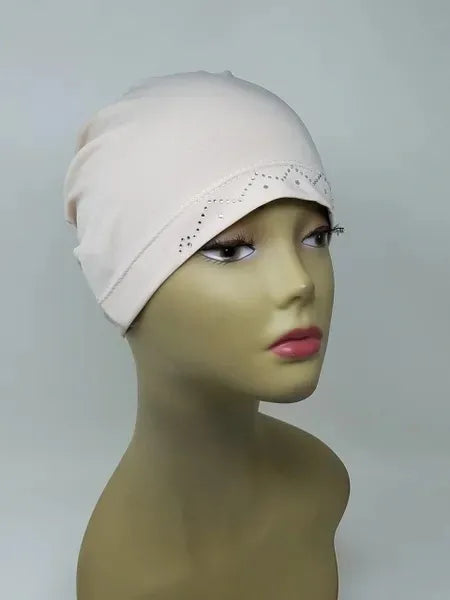 Off white stretch cap hijab on mannequin, soft fitted undercap for women, breathable modest headwear, smooth snug fit, lightweight fabric, cream hijab cap for layering or everyday wear