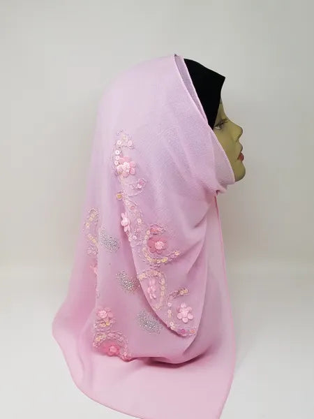 Pink chiffon hijab scarf displayed on mannequin, soft blush flowy fabric with decorative floral details, lightweight breathable modest headscarf for women, elegant drape chiffon hijab for everyday and special occasions, Affordable Hijab USA