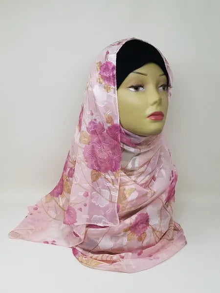 Pink floral georgette hijab draped on mannequin, lightweight breathable scarf with soft flower pattern, textured matte fabric, flowy elegant modest head covering for women, perfect for everyday wear and special occasions
